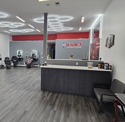 Reception and barber stations at Legacy Barbershop & Lounge, Plano IL, under the honeycomb lights